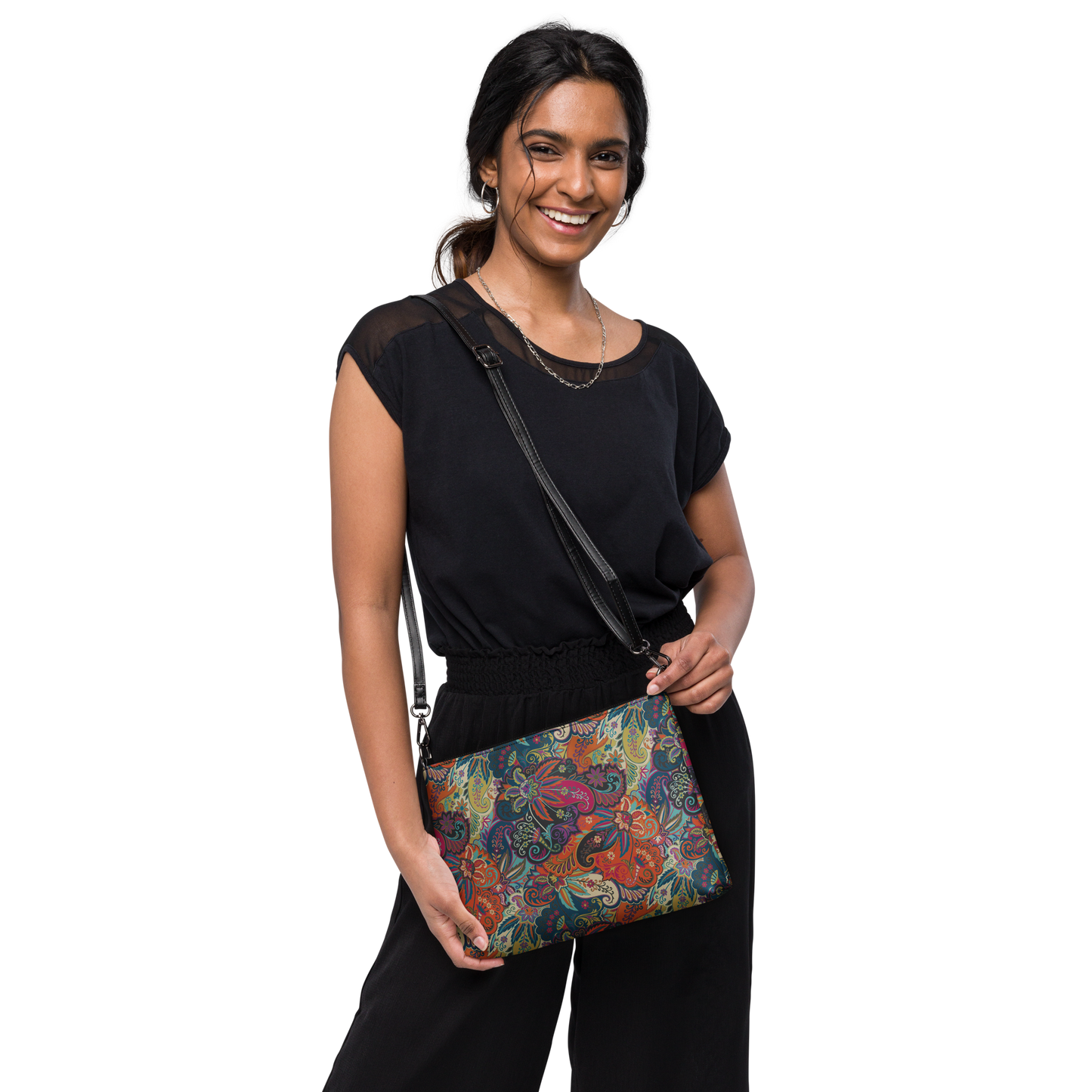 Orange paisley floral crossbody bag with adjustable strap worn over shoulder.