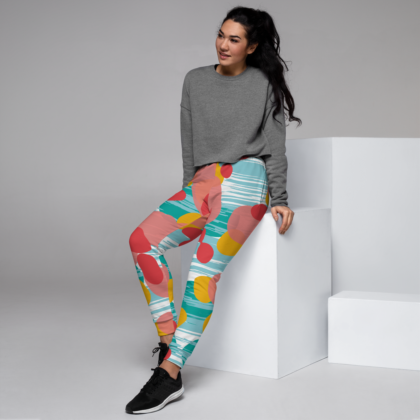 Joggers with red, pink, and yellow dots on white and blue striped background.