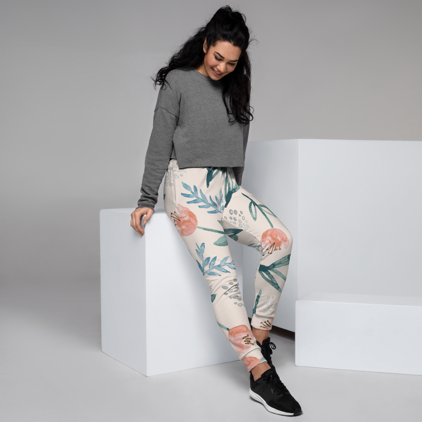 Cream joggers with teal and peach botanical print and elastic waistband.