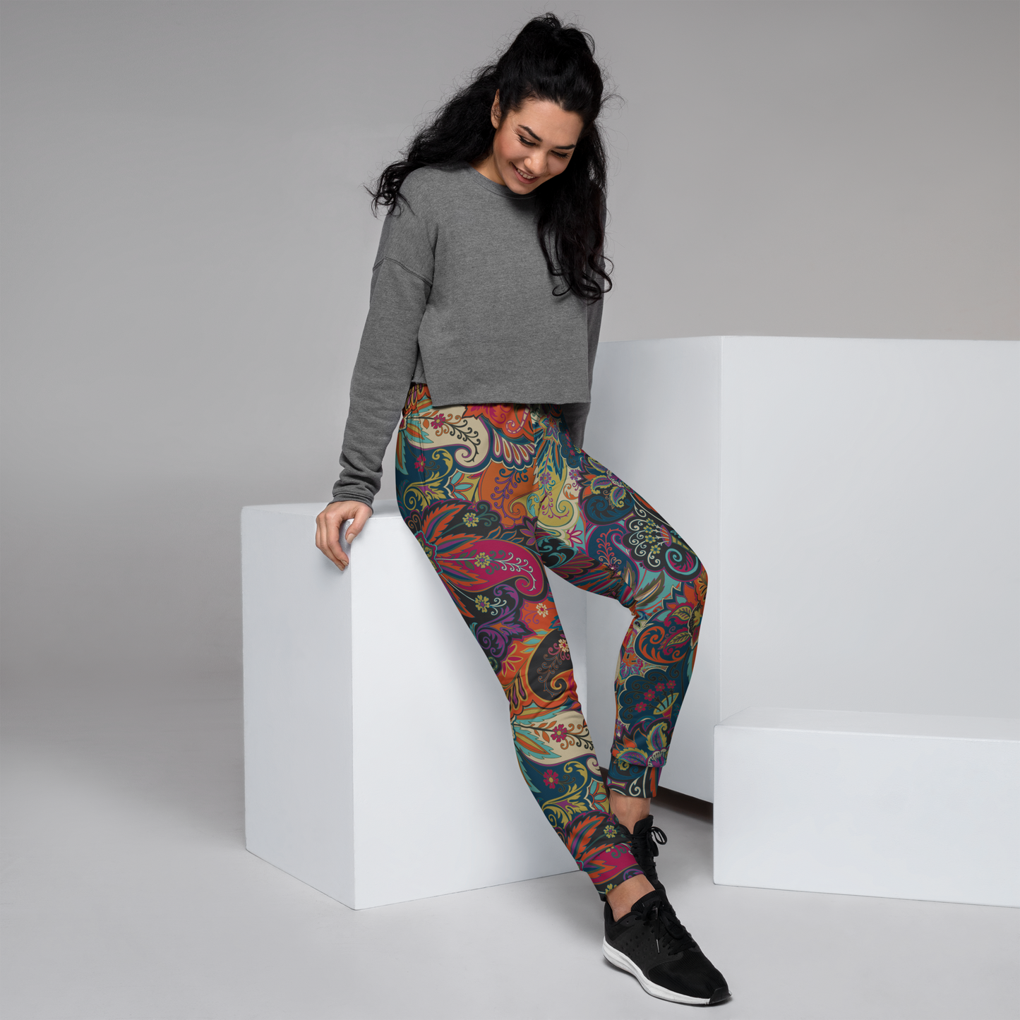 Paisley-inspired women's joggers with swirling blue, coral, and green patterns.