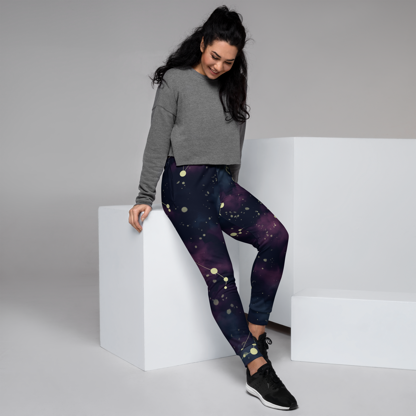 Joggers with celestial pattern in deep blue and purple with starburst dots.