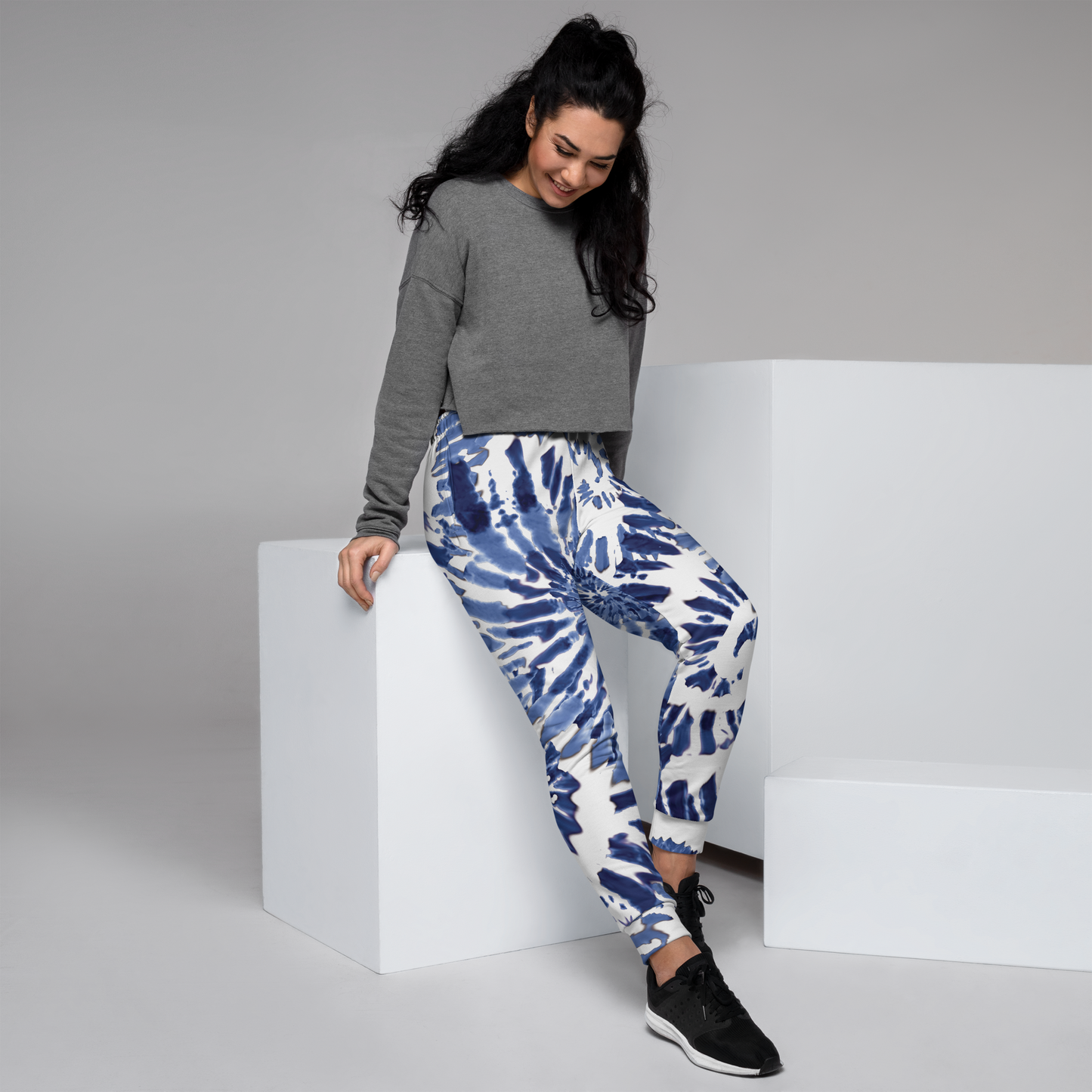 White joggers with blue tie-dye spiral pattern and cuffed ankles.