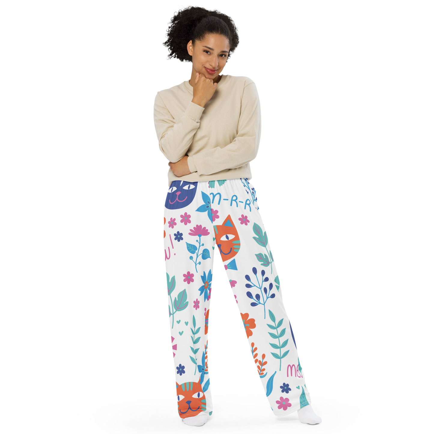 White wide-leg pants with colorful cat faces and floral patterns.