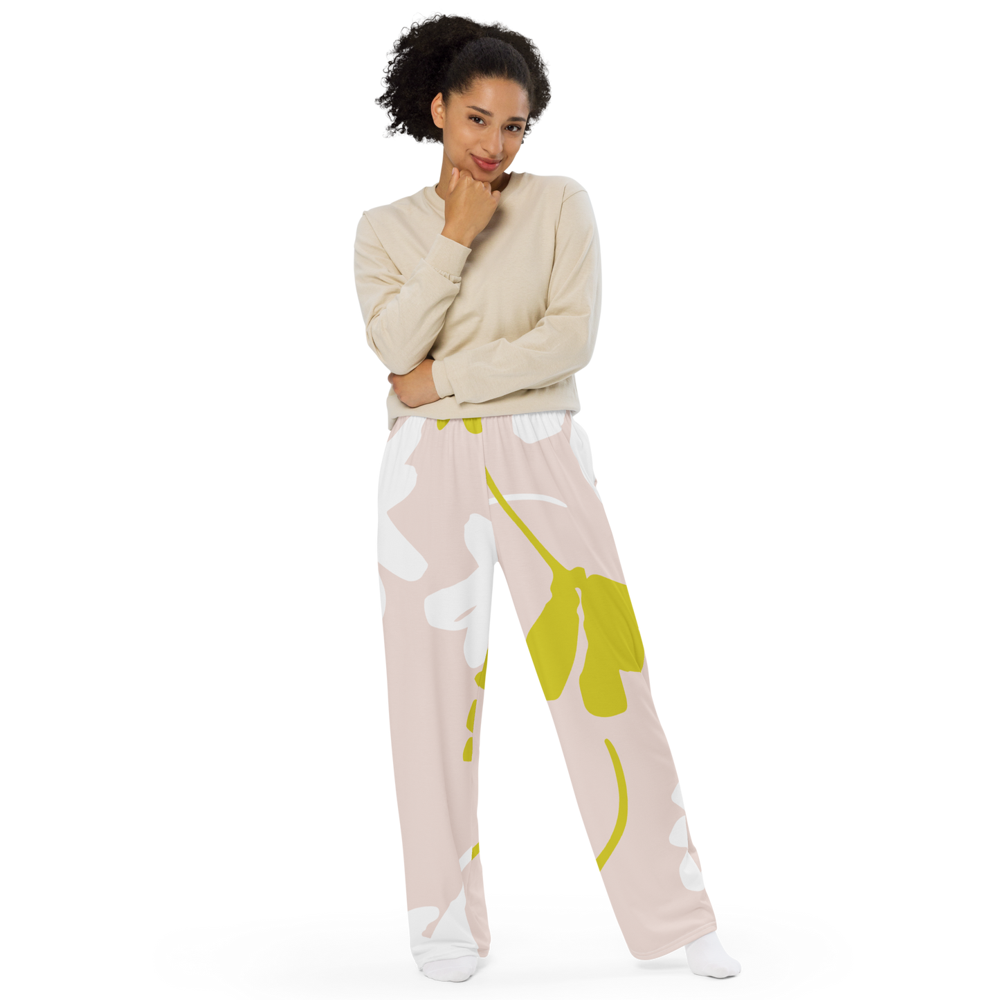 Wide-leg pants with white and olive botanical silhouettes on a beige background.