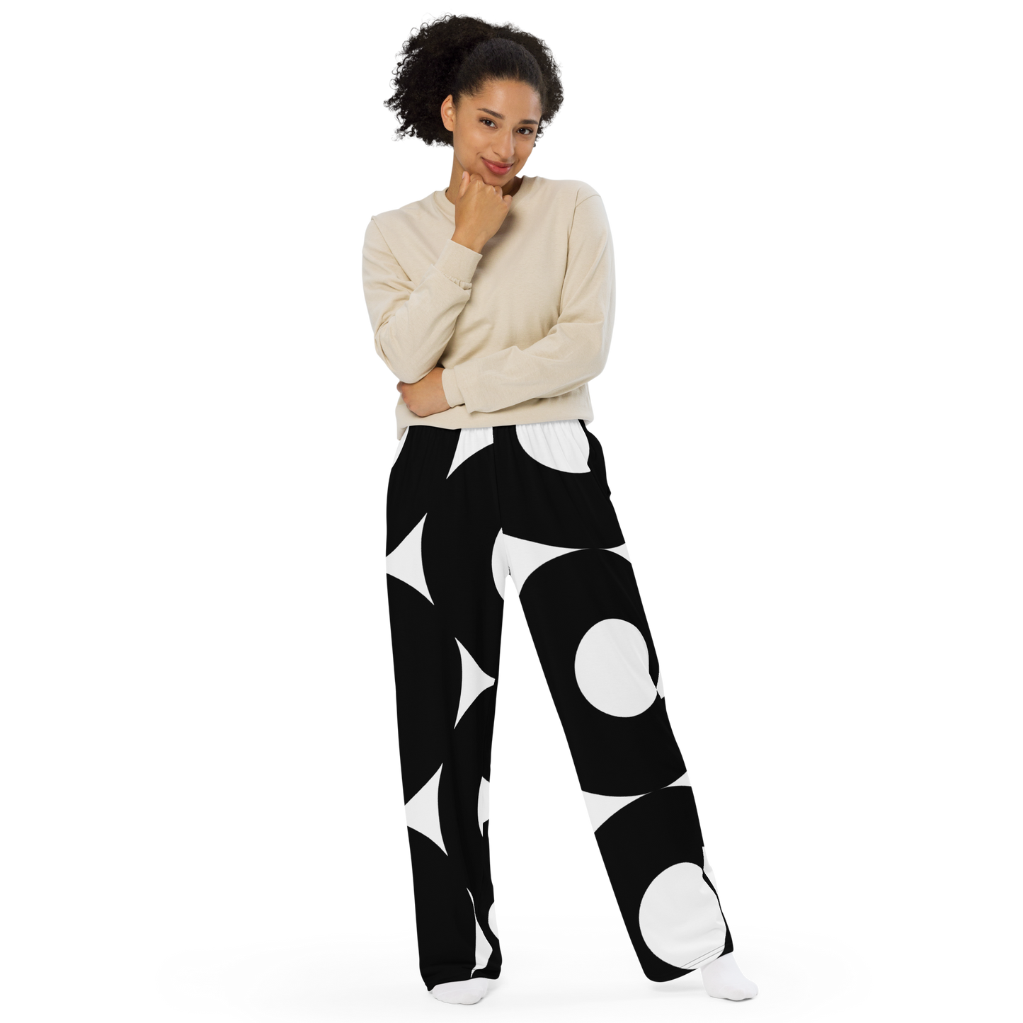 Black and white wide-leg pants with bold circular and geometric patterns.