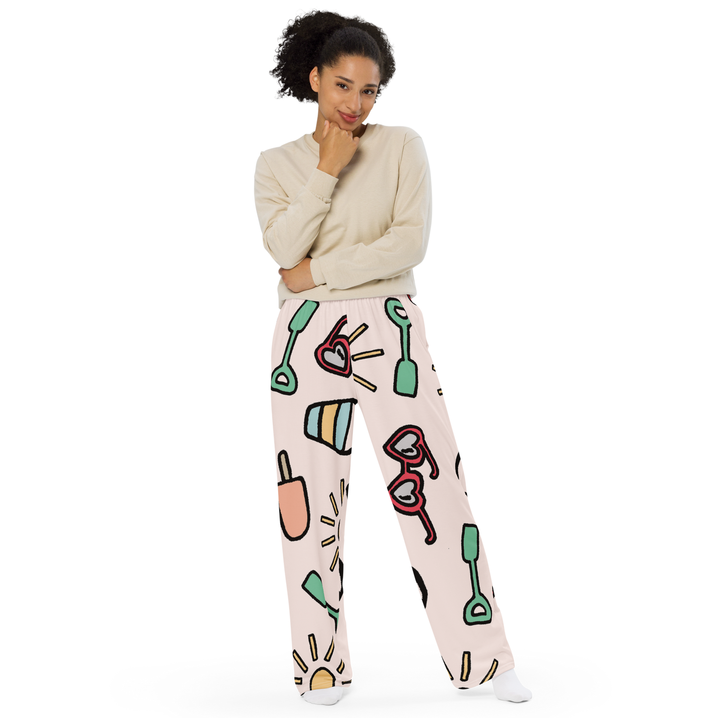 Wide-leg pants with pastel sand toy doodle pattern on a soft background.